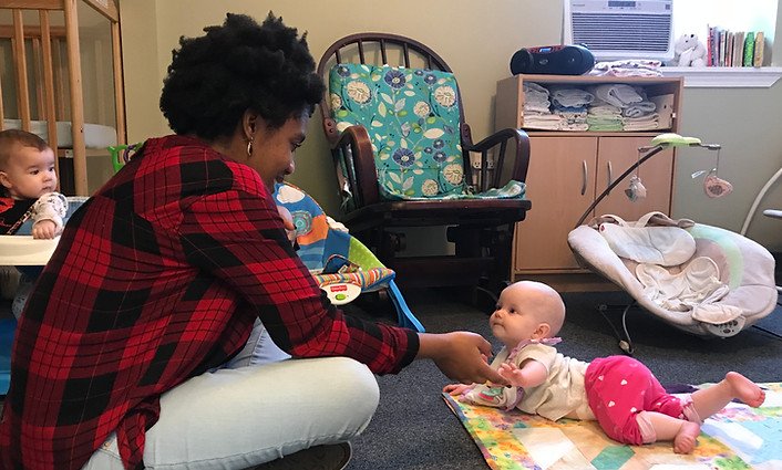 Infant and Teacher Playing