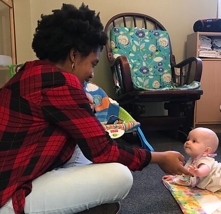 Infant and Teacher Playing